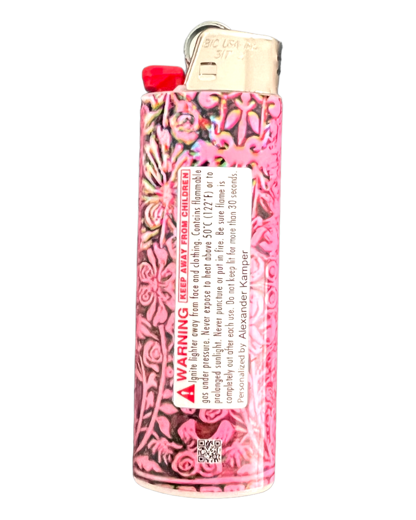 Back side of a pink BIC lighter. Features warning label and QR code.