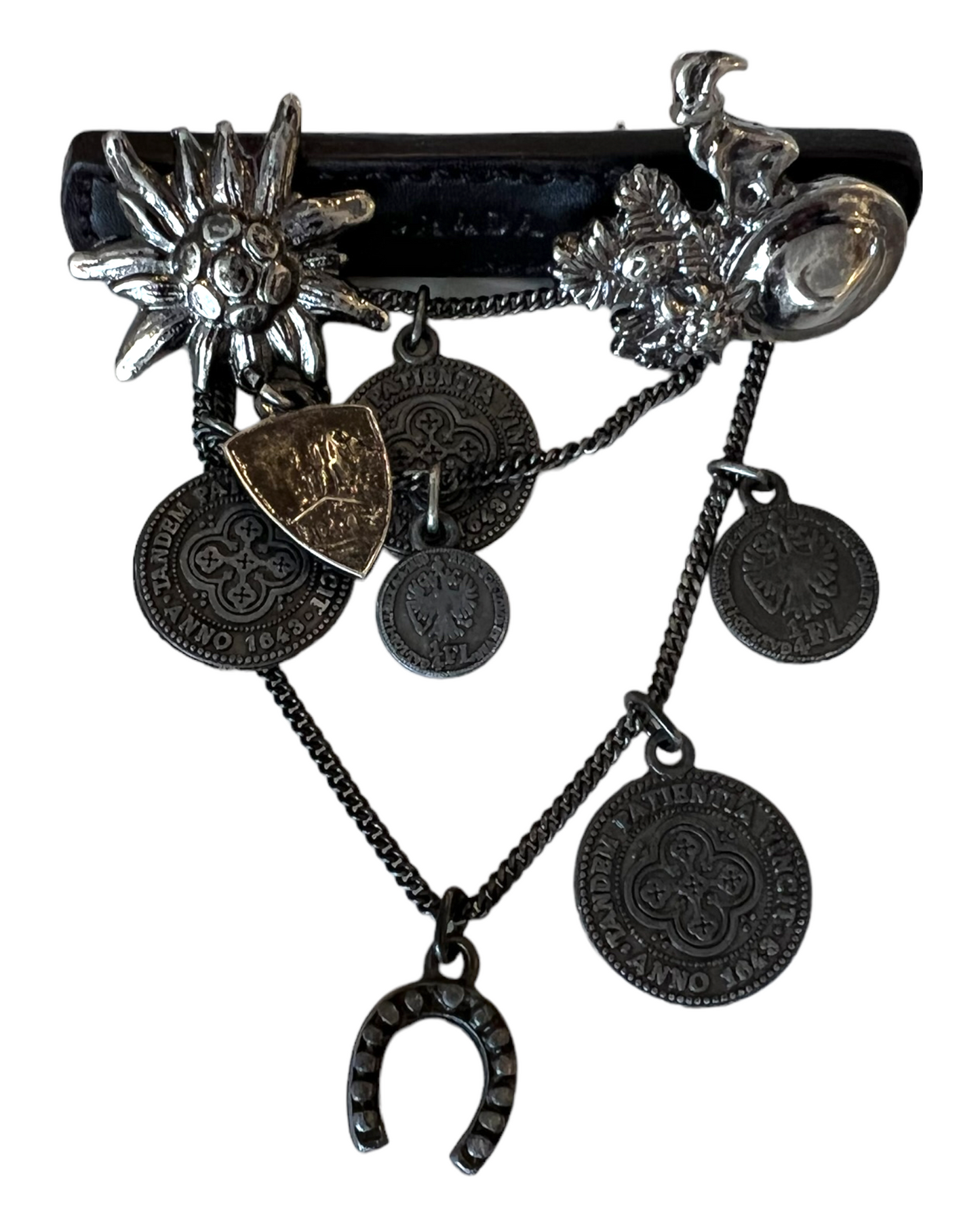Vintage Prada Leather and Silver Cowboy Brooch. Charms include coins, a horseshoe, a goat, a cowboy hat, and a sunburst.