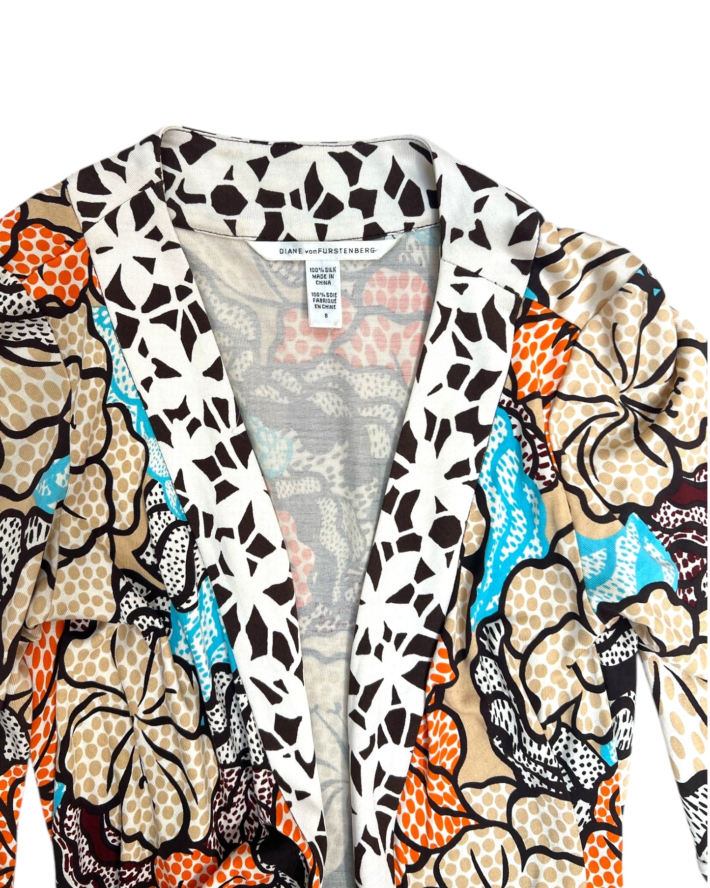 Floral patterned shirt with a plain shirt underneath on a white background