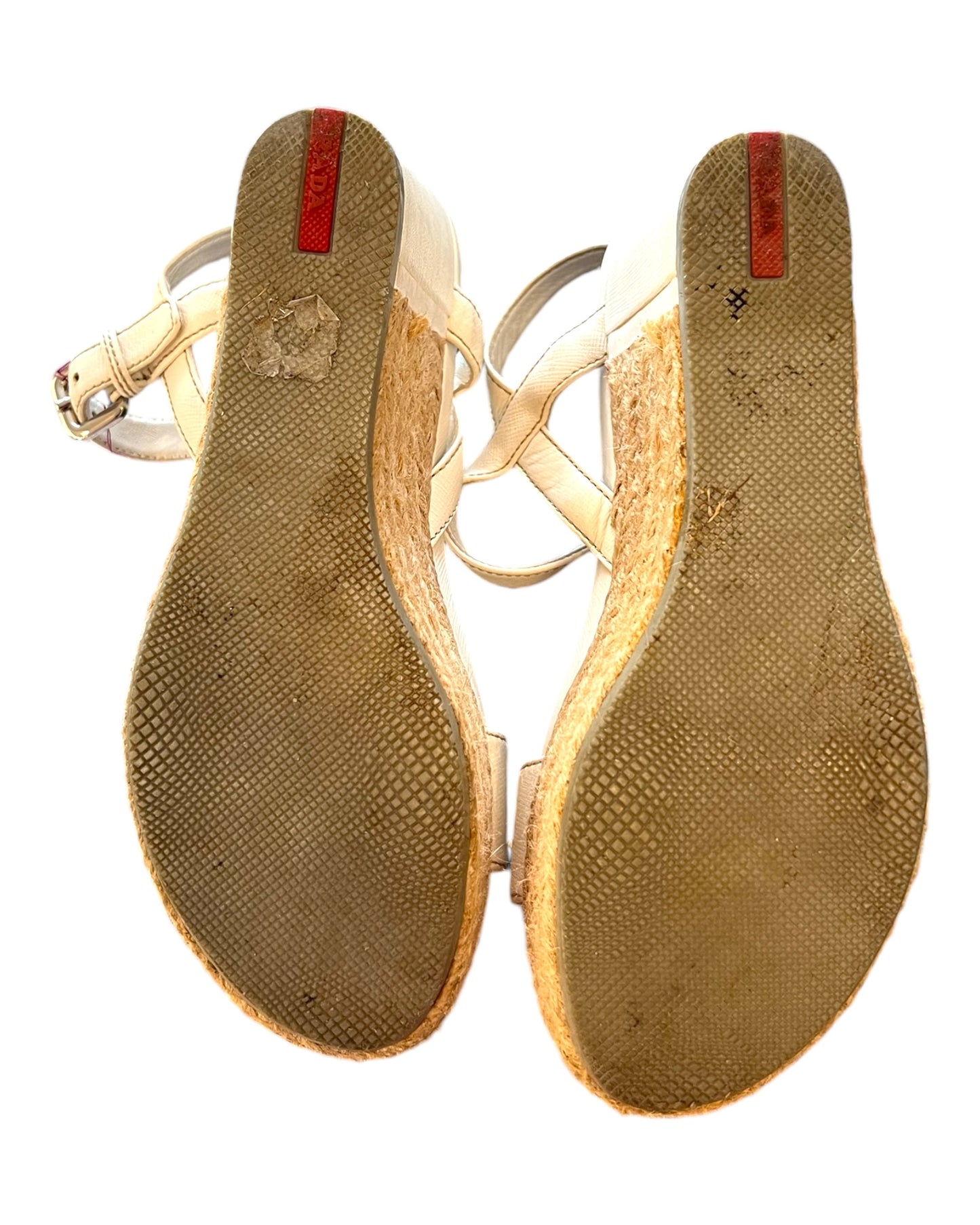 Vintage White Leather and Raffia Prada Wedge Sandals. Image depicts the bottom of the shoes, showing heavy wear.