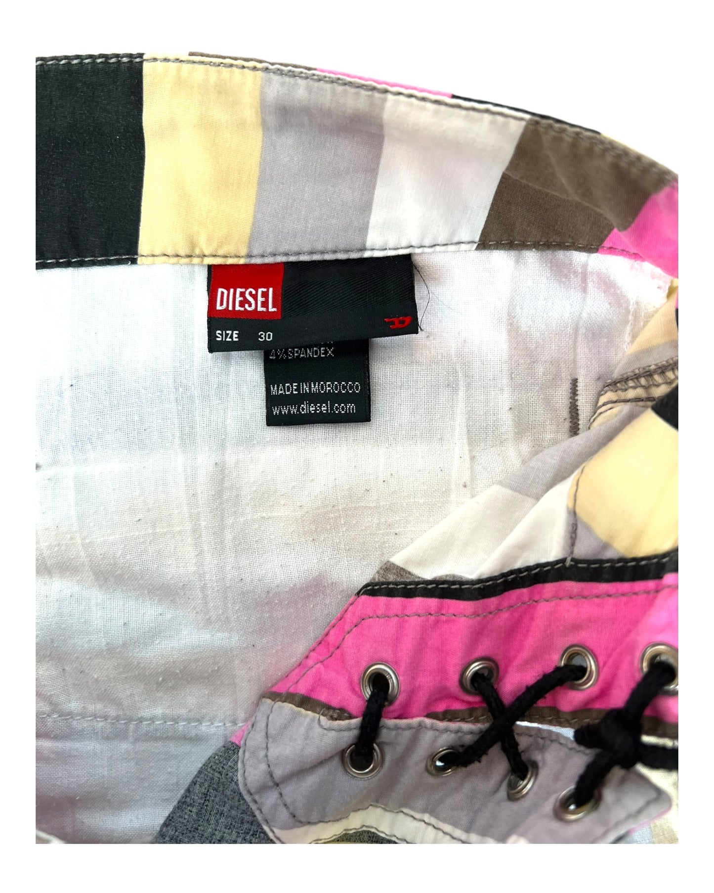 Vintage 2000s Diesel Pinstripe Low-Waist Trousers. Featuring dual lace up closures. Colors are pink, grey, black, blue, and beige. Image depicts the size and brand tag.