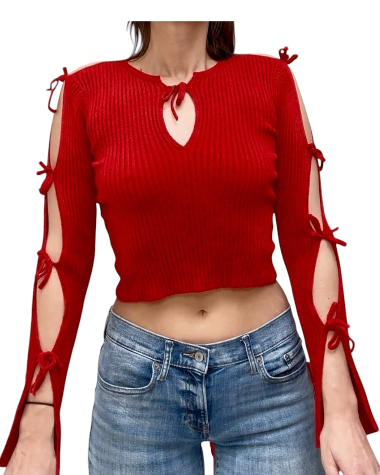 Red ribbed long-sleeve top with cut-out design and tied sleeves worn by a person, paired with blue jeans on a white background.
