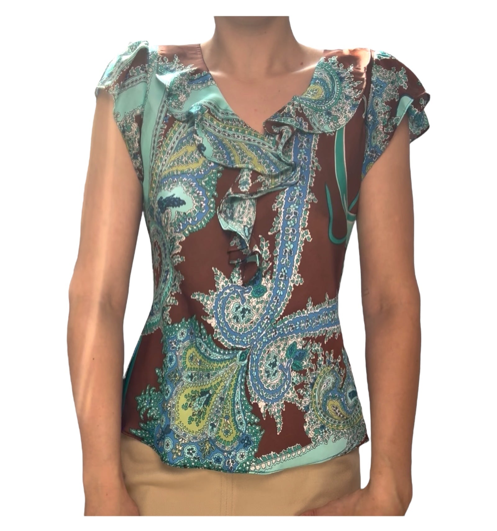 Colorful patterned top worn by a person on a white background
