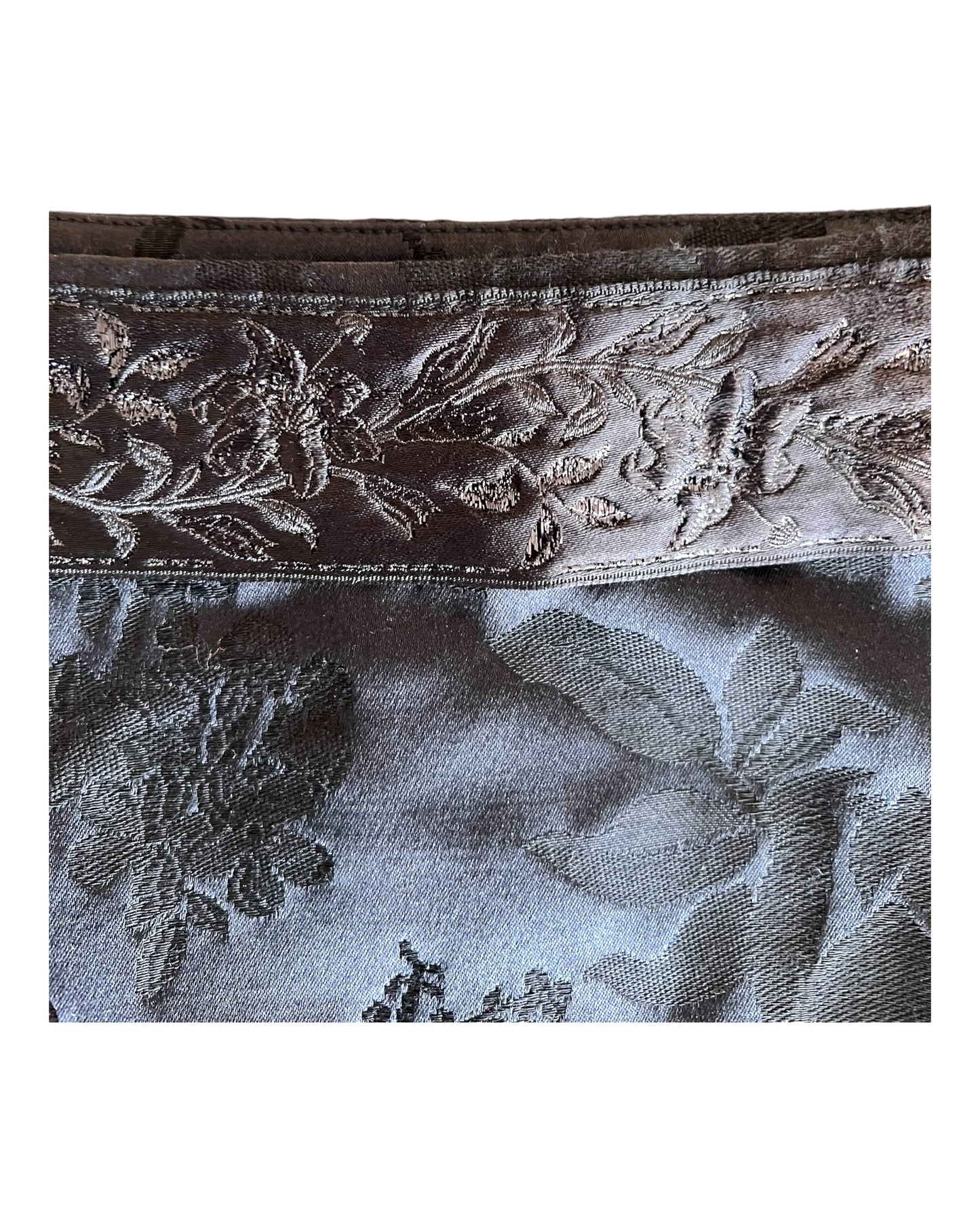 Vintage Miu Miu black skirt with a baroque pattern. Image depicts a close-up of the pattern