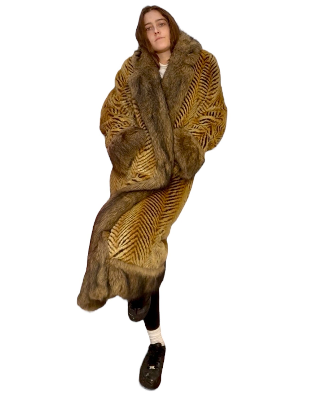 Person wearing a long, patterned fur coat on a white background