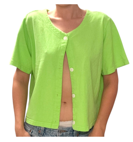 Person wearing a bright green button-up shirt over a white shirt, on a white background