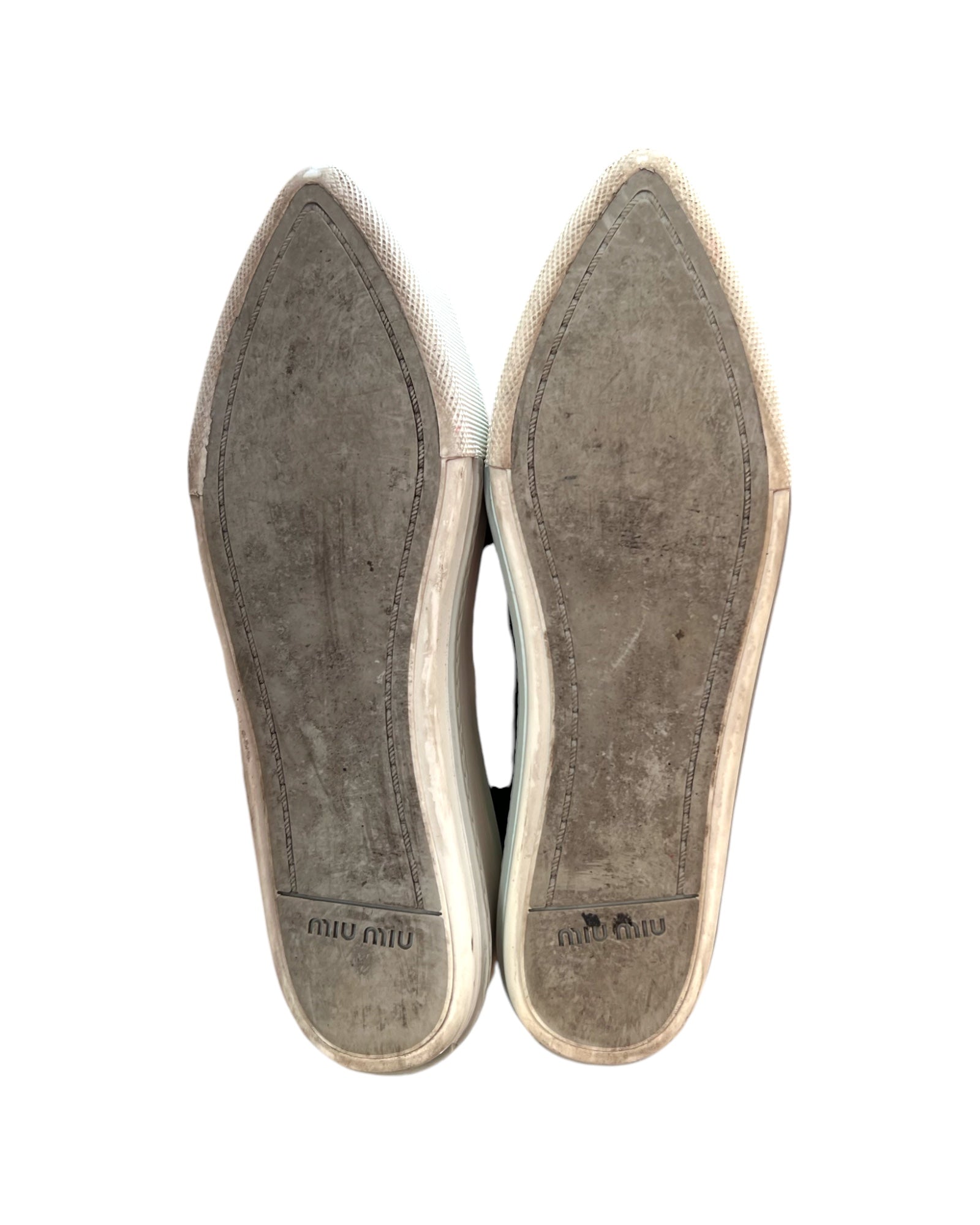 Pre-loved Miu Miu leather platform loafers. Shoes feature a leather mesh body with a silver-toned metal toe tip. Platform is approximately 2 inches in height. Image depicts the bottom of the shoes, showing heavy wear. 